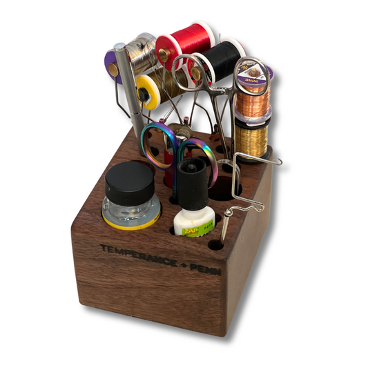 Handcrafted walnut fly tying tool organizer by Temperance & Penn, designed to store your favorite fly tying supplies, including spools, scissors, and adhesives. Compatible with Dynaking, Regal, Norvise, and Renzetti vises. Perfect for anglers seeking a sustainable and stylish fly tying station.