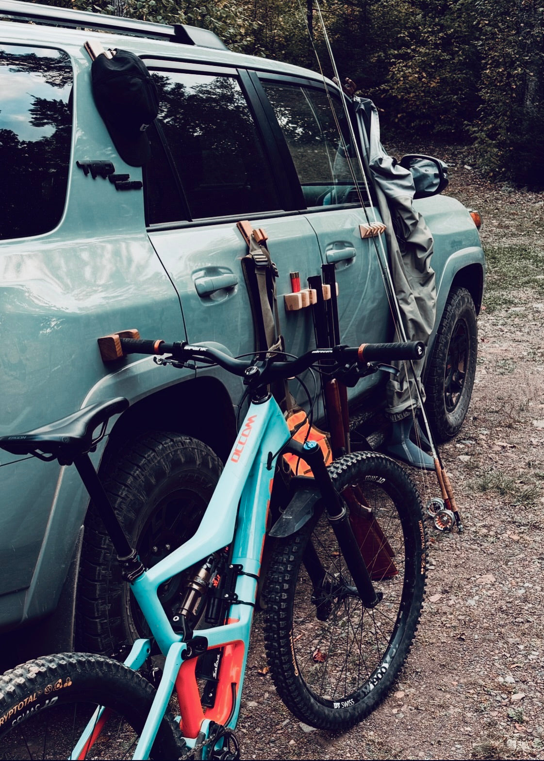 Mountain bike and Fishing Rod mounted to truck using HandleHitch magnetic bike and Fishing Rod holder by Temperance + Penn, ideal for trailhead and garage storage