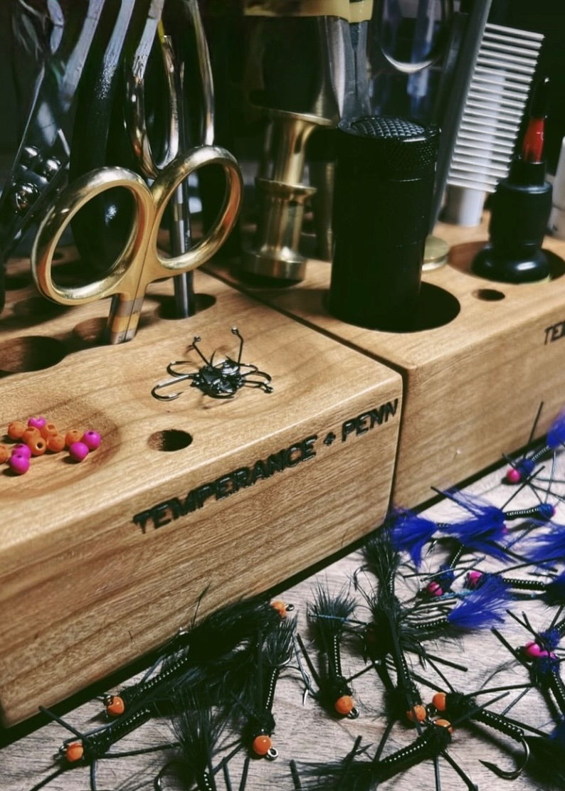 Handcrafted wooden fly tying tool caddy holding fly tying tools, finished flies, beads, and hooks, built for anglers and tiers.